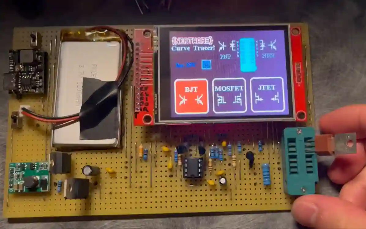 Handheld curve tracer with touchscreen display for transistor measurements, mounted on a Perfboard with other circuit components